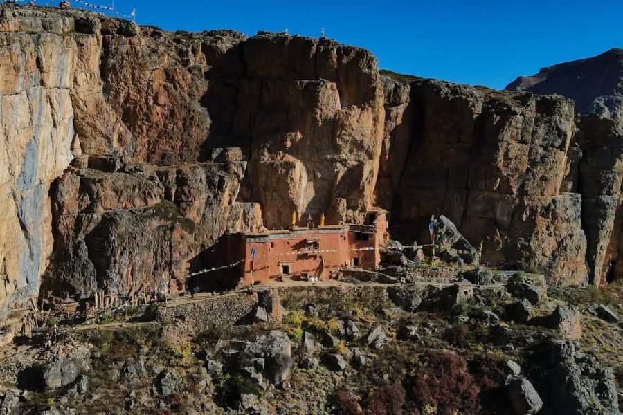 Ancient monastery built into dramatic red rock cliffs in Upper Dolpo